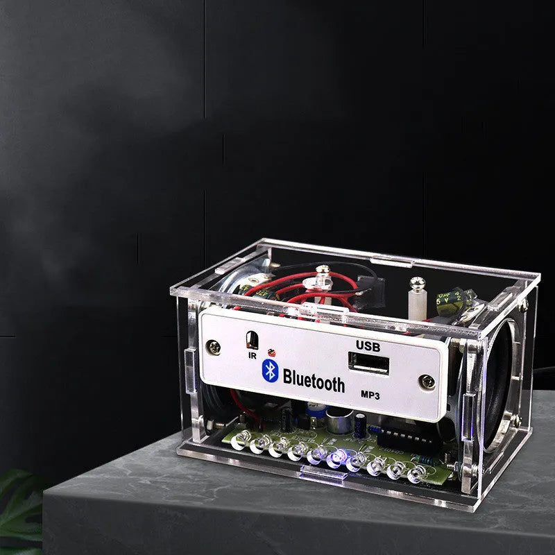 DIY bluetooth speaker assembly kit showing electronic components and transparent shell enclosure