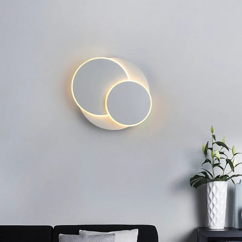 Modern round acrylic wall lamp in black or white, shown in large, medium, and small sizes.