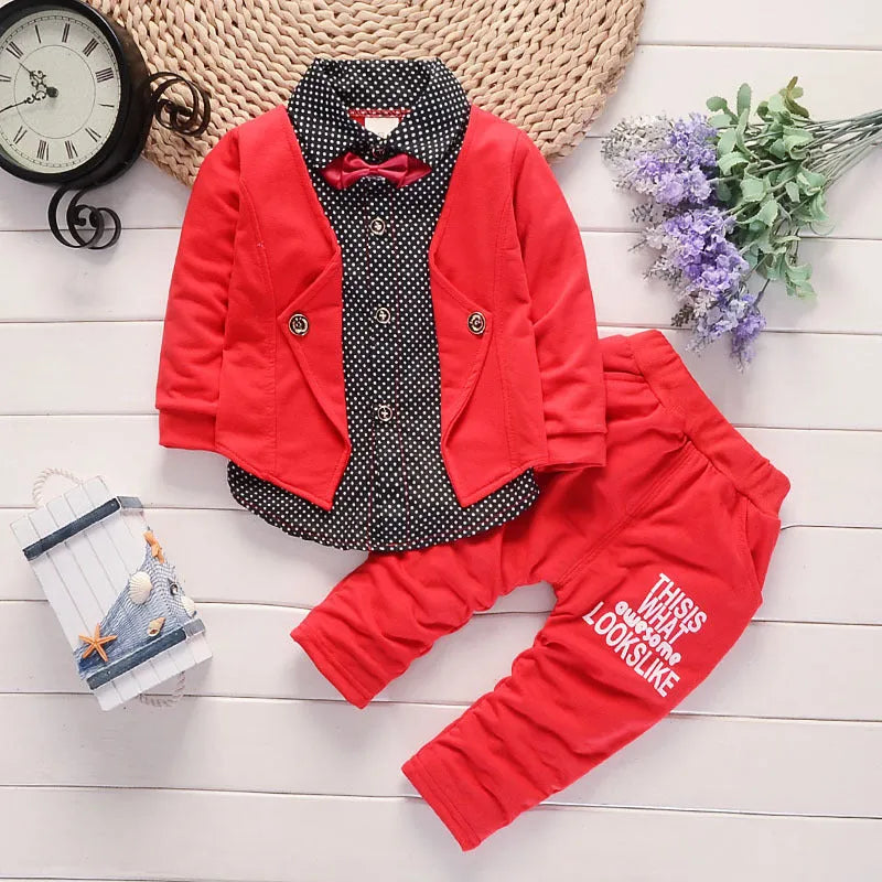 Toddler boy wearing a grey casual printed suit set with jacket and trousers.