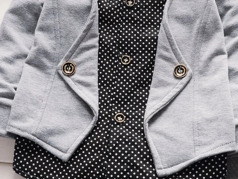 Toddler boy wearing a grey casual printed suit set with jacket and trousers.