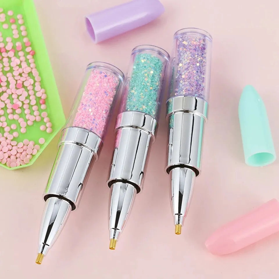 A plastic diamond painting point drill pen shown in pink, purple, and green colour options.