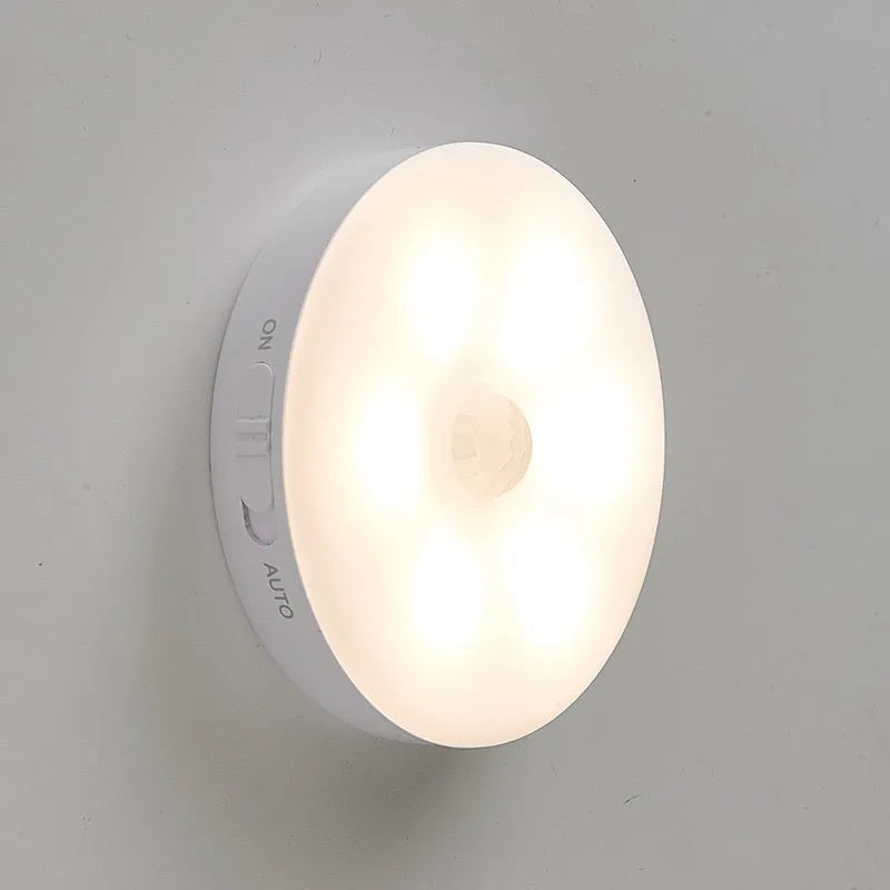 Two compact wireless motion sensor lights with induction charger.