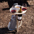 Outdoor foldable wooden wine rack with wine bottle and glasses on beach