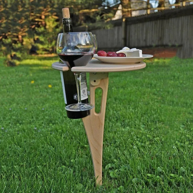 Outdoor foldable wooden wine rack with wine bottle and glasses on beach