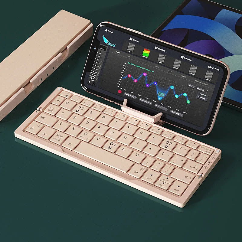 Silver and black grey foldable Bluetooth keyboard open with stand holding a mobile phone