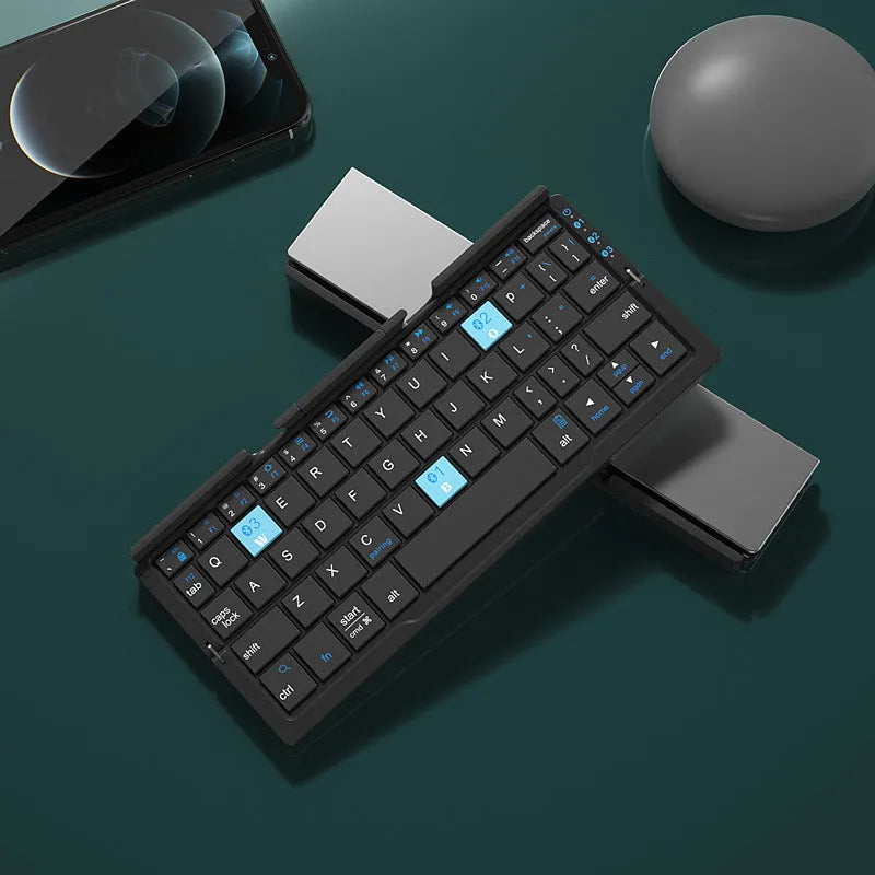 Silver and black grey foldable Bluetooth keyboard open with stand holding a mobile phone