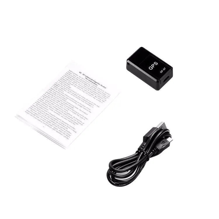 Small black magnetic GPS tracker device next to a USB charging cable.