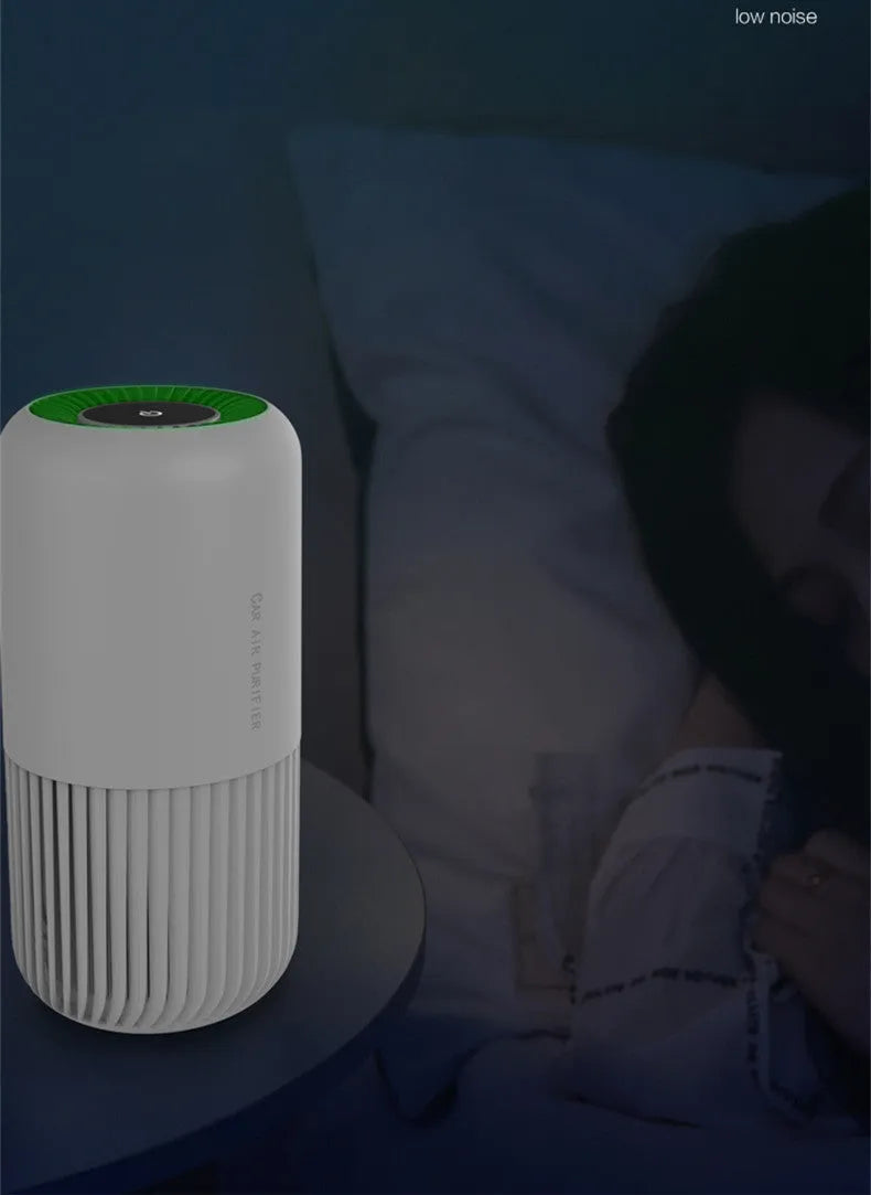Compact black USB air purifier for car and desktop use with HEPA and UV filtration.