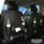PU leather car seat back organiser bag with zipped main pocket and mesh side holders.
