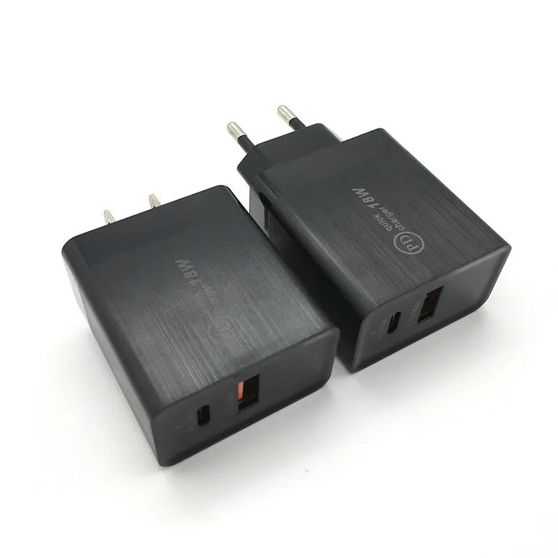 White 18W USB-C PD fast charger wall adapter with US plug on a table.