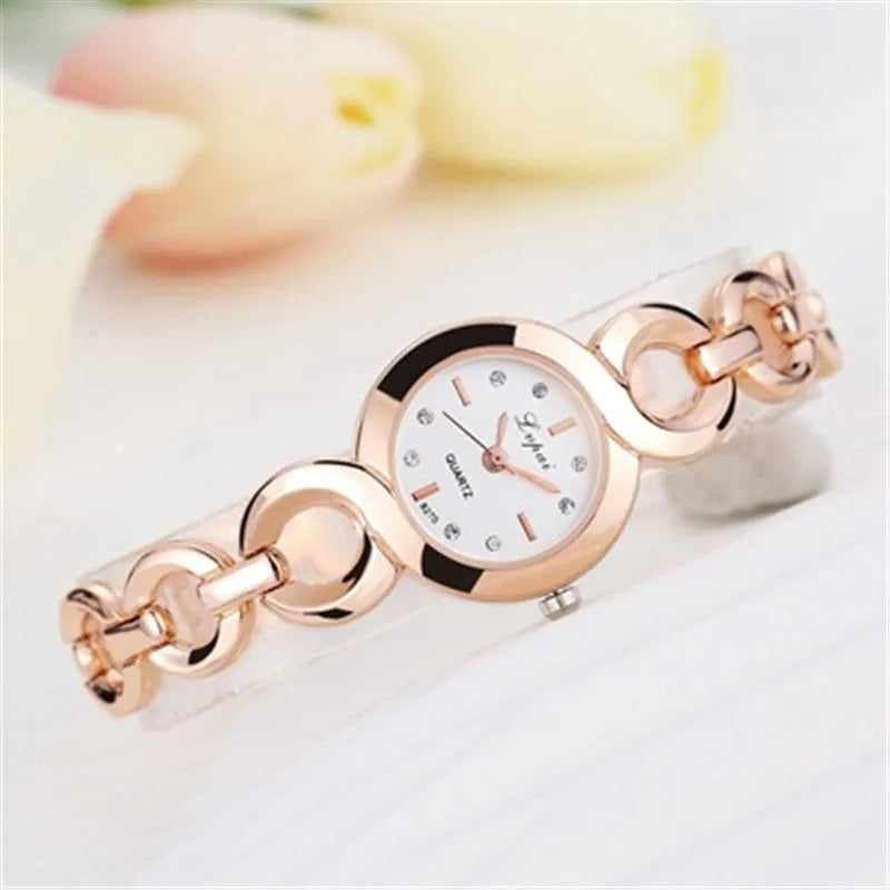 Alloy quartz watch with 2.4cm gold-tone dial and 19.5cm strap in rose gold black colour.