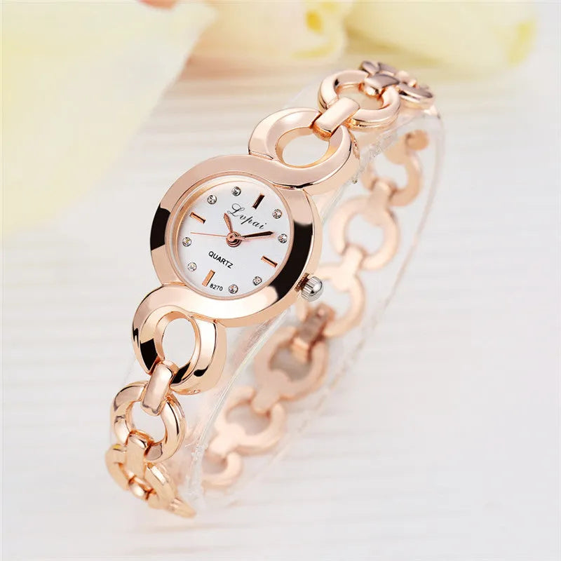 Alloy quartz watch with 2.4cm gold-tone dial and 19.5cm strap in rose gold black colour.