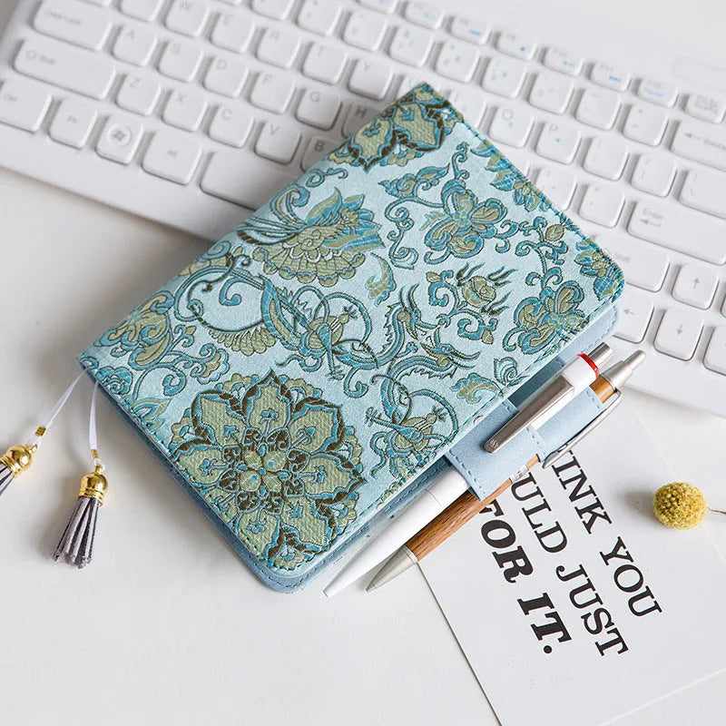 Fabric-covered Flying Blue Flower notebook in A5 and A6 sizes with 100g paper.