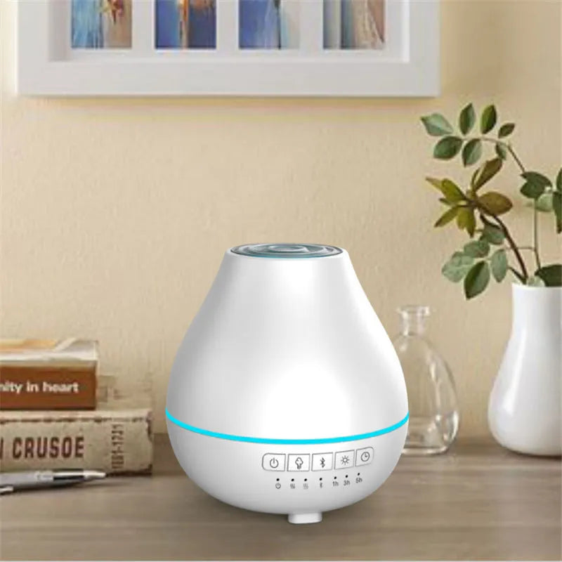 White round Bluetooth humidifier and aroma diffuser with night light on a surface.