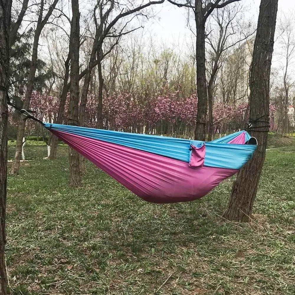 Nylon rope hammock in blue with anti-rollover design and mosquito net for outdoor camping use