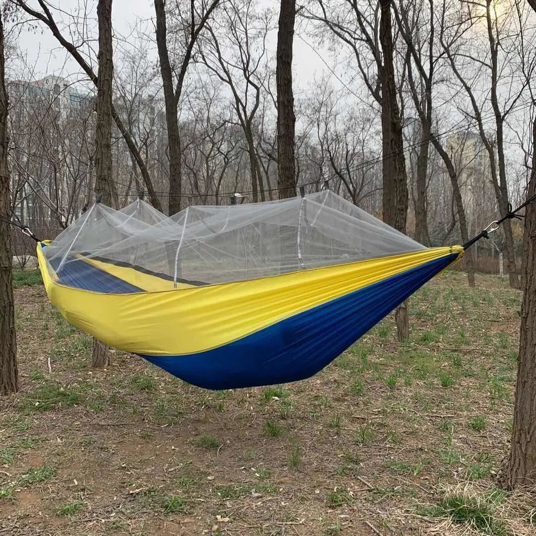 Nylon rope hammock in blue with anti-rollover design and mosquito net for outdoor camping use