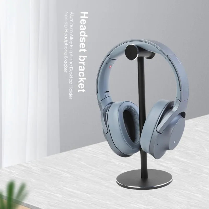 Black aluminium alloy headset bracket holding earphones on a desk