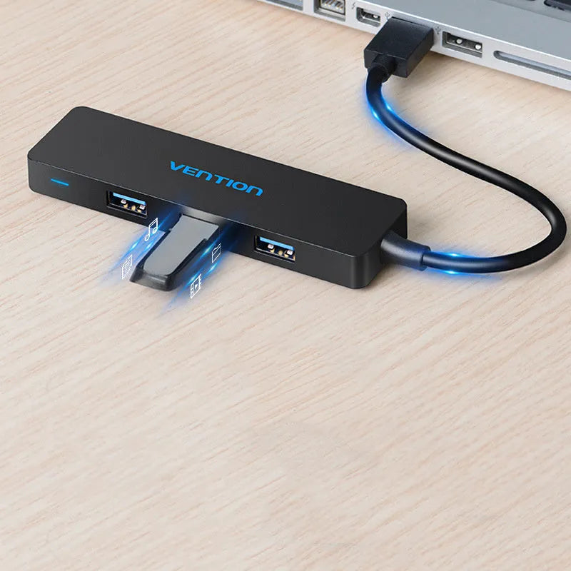 Black four-port USB 3.0 hub with a short 15cm cable on a desk