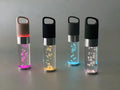 Compact pink Bluetooth speaker with colourful crystal LED lights, showing front and side.