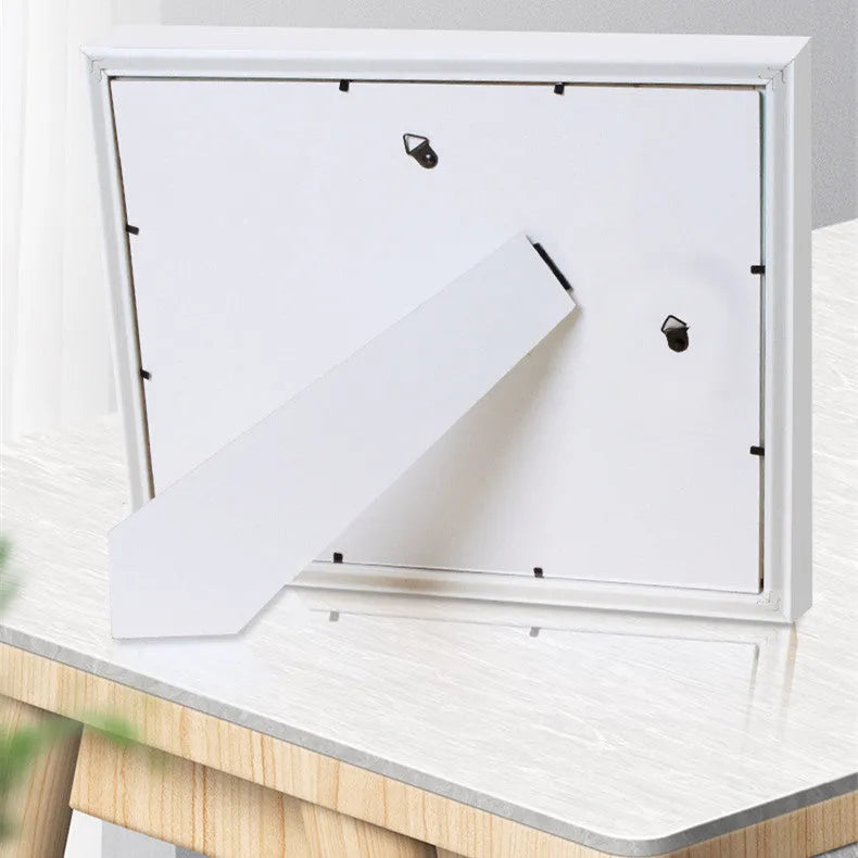 A modern DIY frame for displaying a baby's hand and foot prints, shown in a choice of colours.