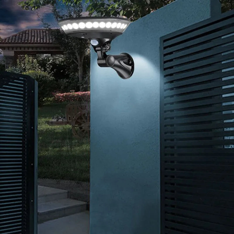 White 360-degree solar-powered security light with motion sensor on wall.