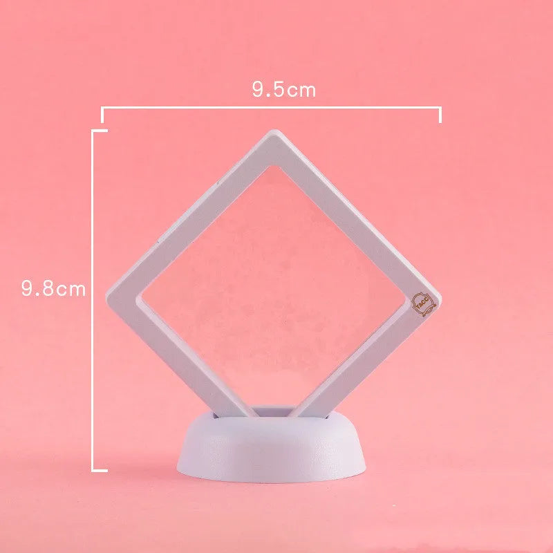 3D floating display case holding coins and jewellery between transparent membrane sheets