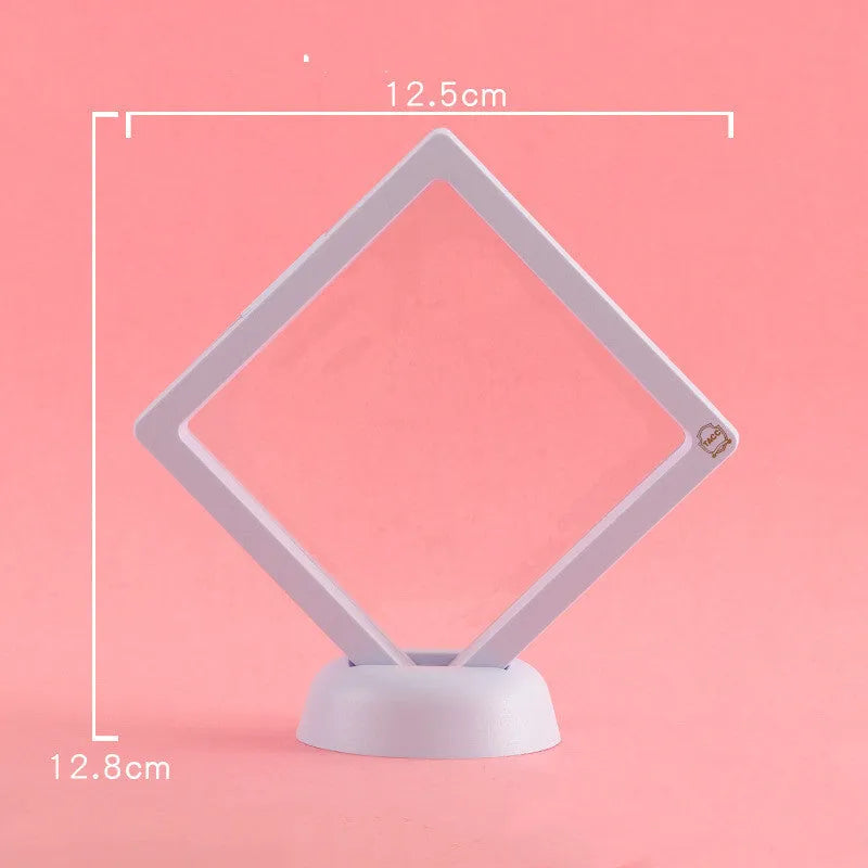 3D floating display case holding coins and jewellery between transparent membrane sheets