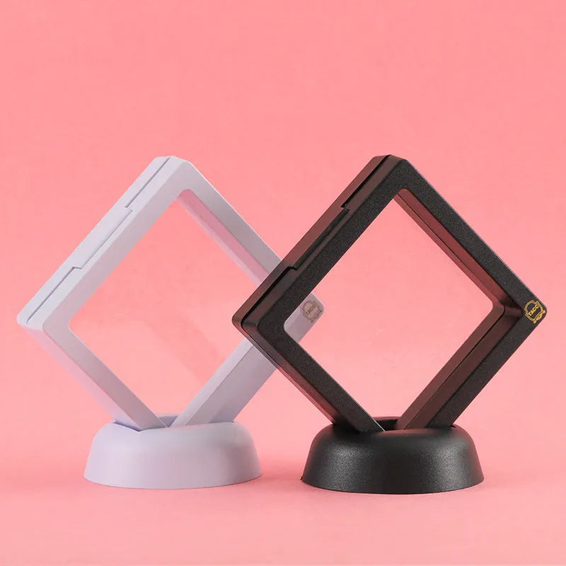 3D floating display case holding coins and jewellery between transparent membrane sheets