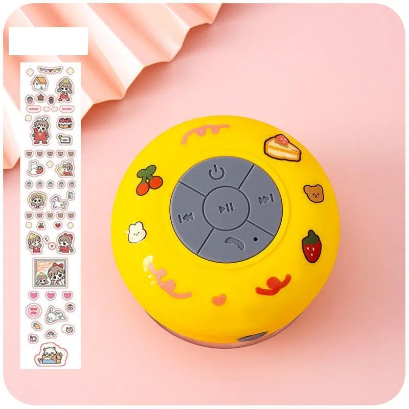 Small waterproof Bluetooth speaker with suction cup base in blue colour on bathroom tiles