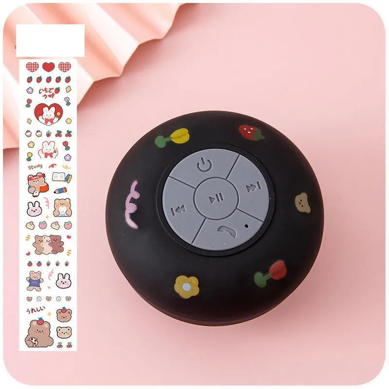 Small waterproof Bluetooth speaker with suction cup base in blue colour on bathroom tiles