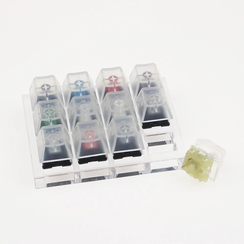 White Cherry mechanical keyboard switch tester showing twelve different MX switches.