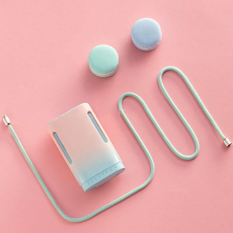 Compact jelly hanging neck fan in mint peach colour, showing USB port and neck strap.