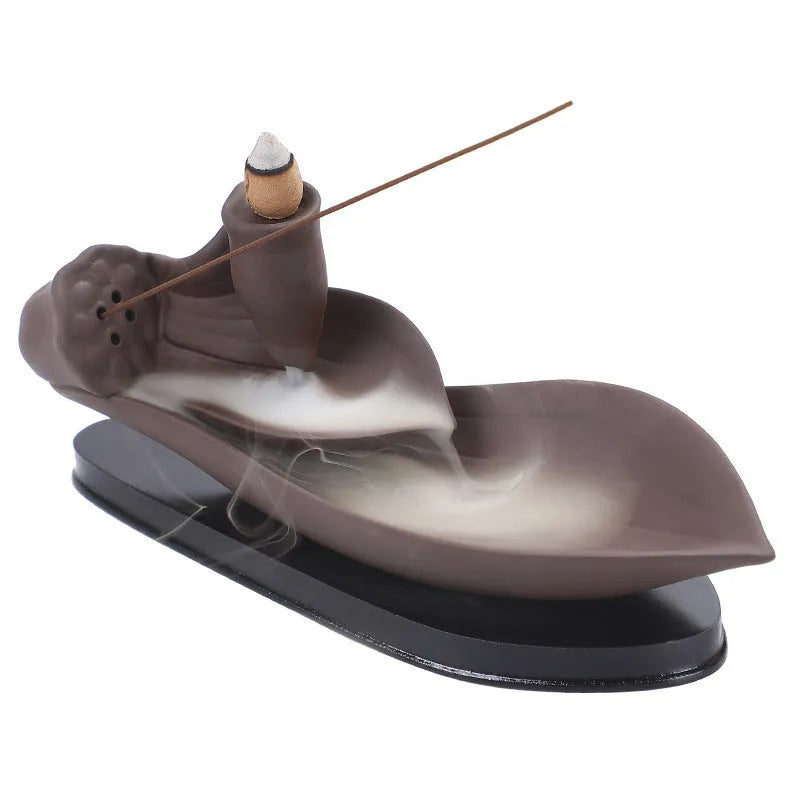 Brown purple sand backflow incense burner 8.5x21x9 cm on a wooden surface with smoke flowing downwards