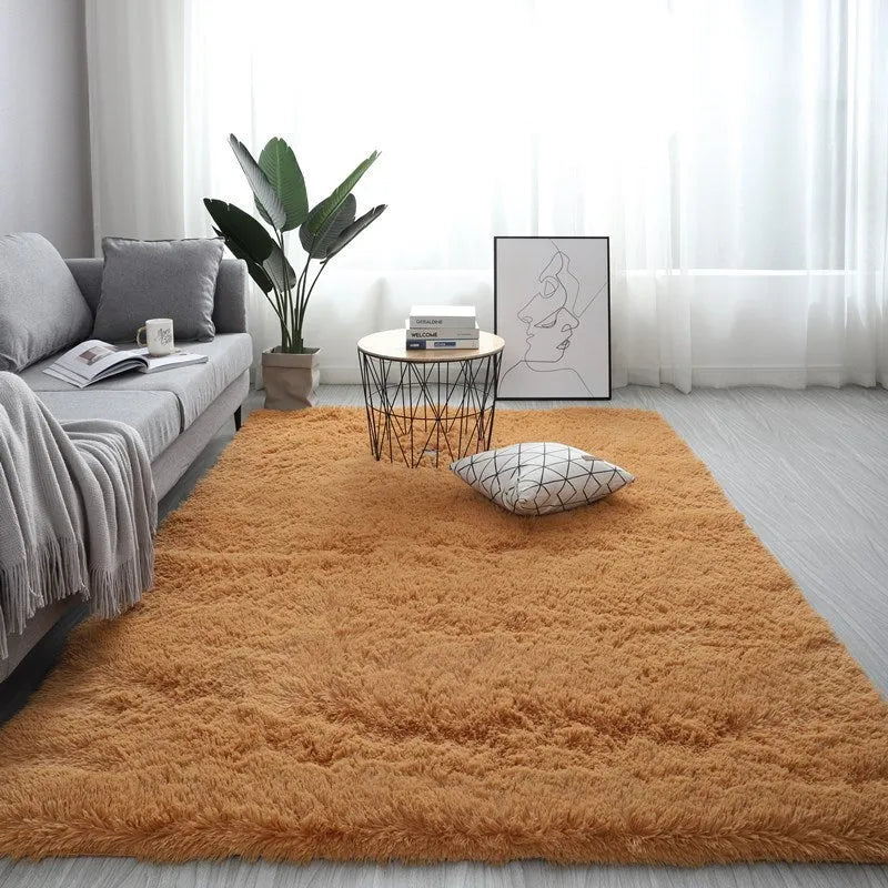 Nordic style rectangular plush carpet in a light colour on a wooden floor, showing fluffy texture.