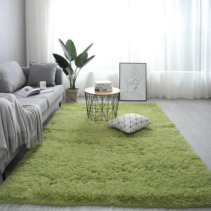Nordic style rectangular plush carpet in a light colour on a wooden floor, showing fluffy texture.