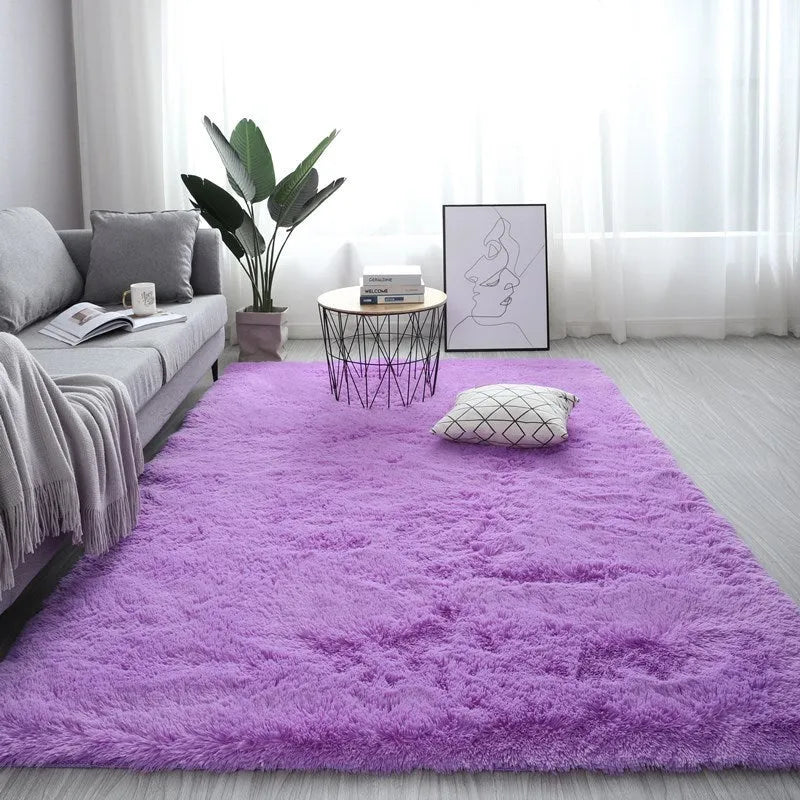 Nordic style rectangular plush carpet in a light colour on a wooden floor, showing fluffy texture.