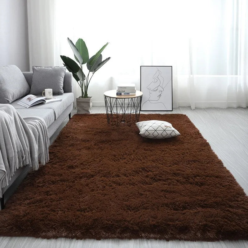 Nordic style rectangular plush carpet in a light colour on a wooden floor, showing fluffy texture.