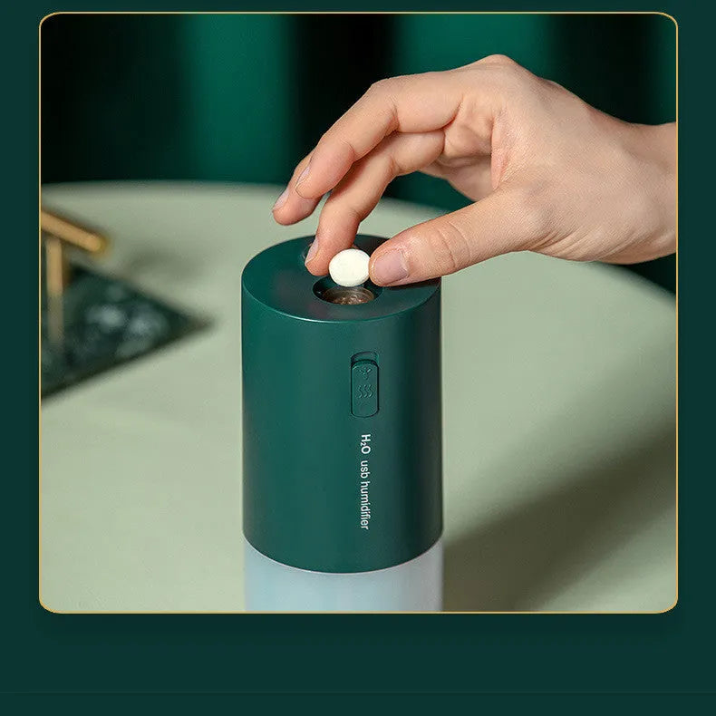 Blue columnar USB desktop humidifier with aromatherapy function on a wooden table