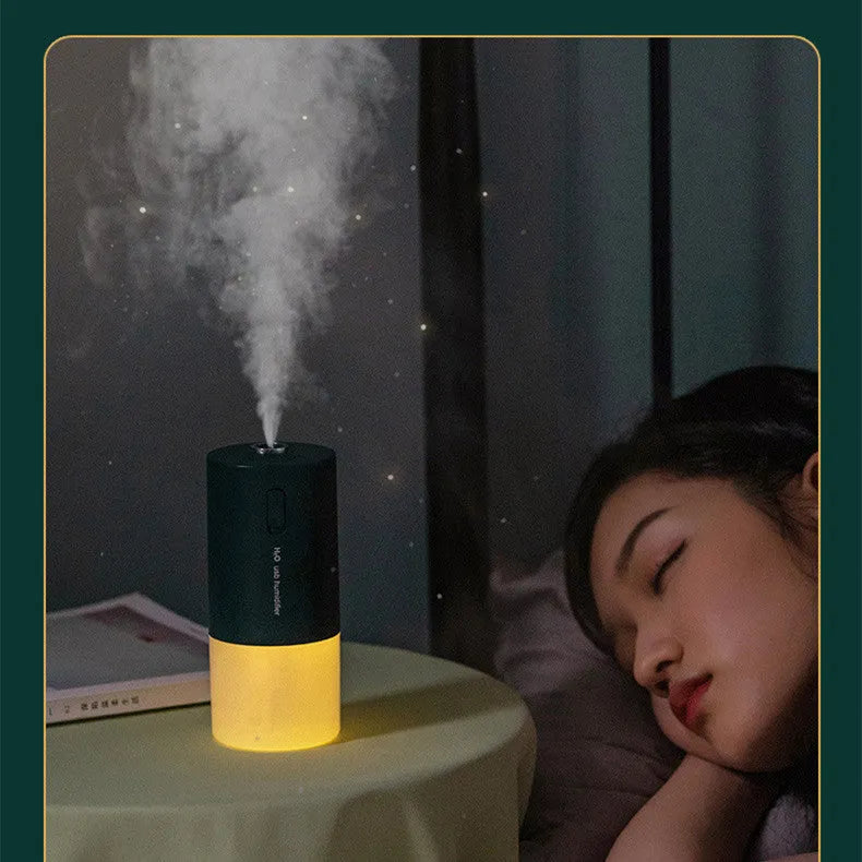 Blue columnar USB desktop humidifier with aromatherapy function on a wooden table