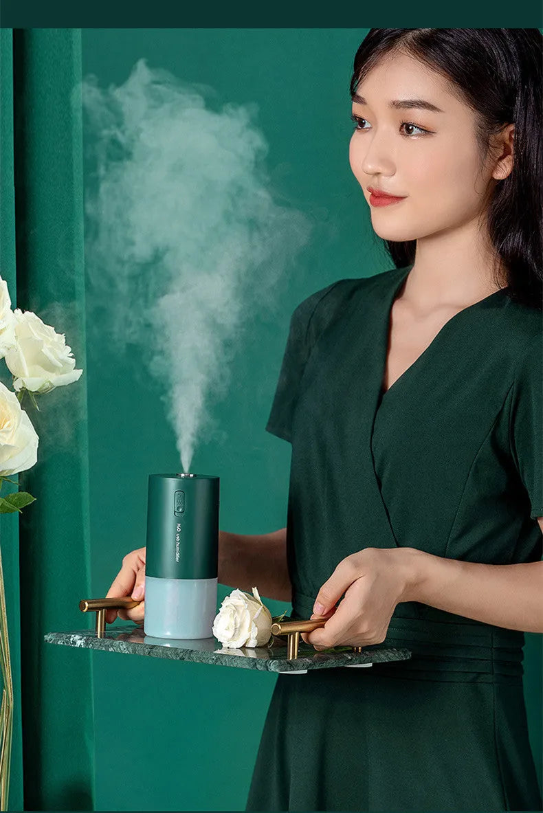 Blue columnar USB desktop humidifier with aromatherapy function on a wooden table