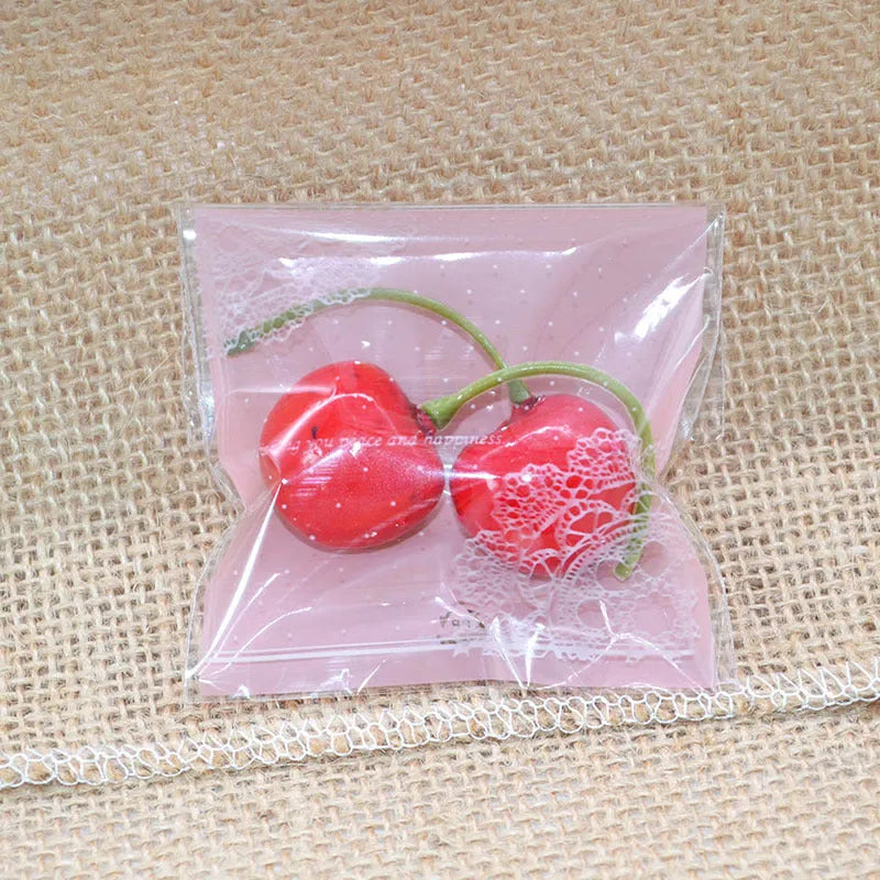Pink self-adhesive plastic packaging bags with UV printing, shown sealed and open.
