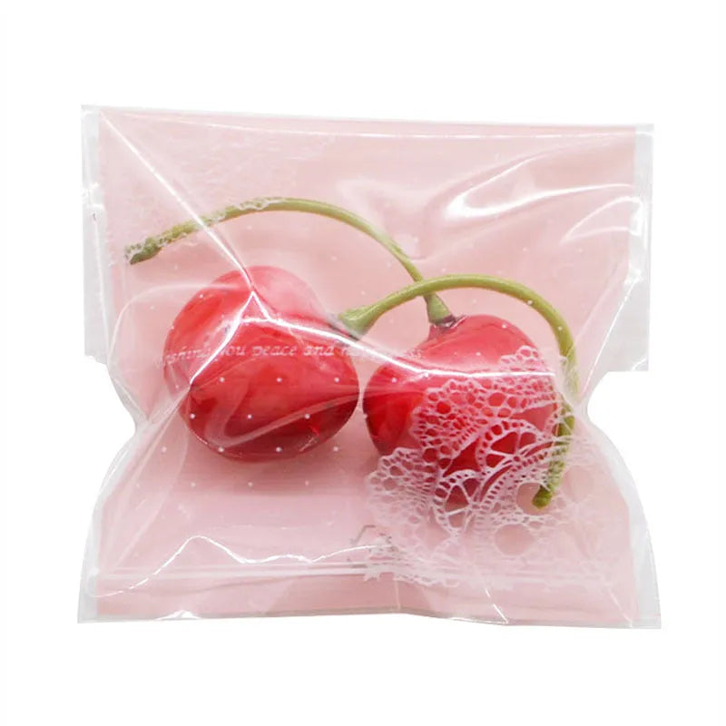 Pink self-adhesive plastic packaging bags with UV printing, shown sealed and open.