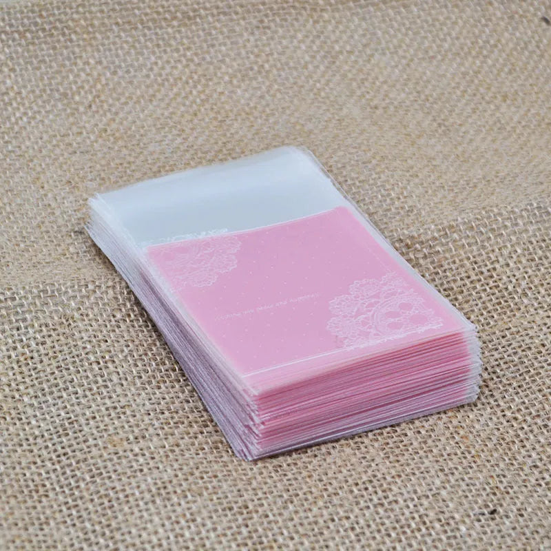 Pink self-adhesive plastic packaging bag with a 3cm header, shown sealing a bar of handmade soap.
