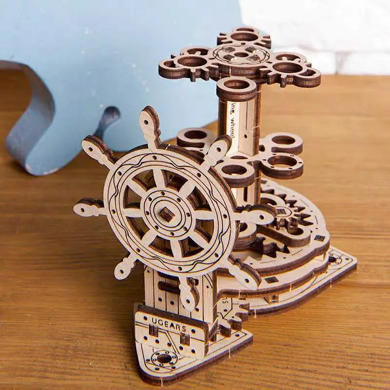 Ukrainian wooden rotating machinery model pen holder on a desk.