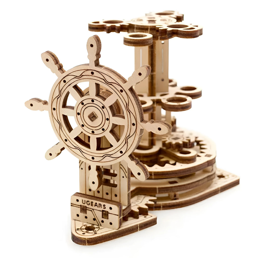 Ukrainian wooden rotating machinery model pen holder on a desk.