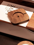 Walnut wood magnetic wireless charging bracket base on desk with phone