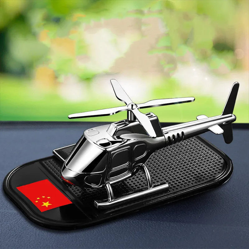 Helicopter car interior decoration model in silver colour on car dashboard
