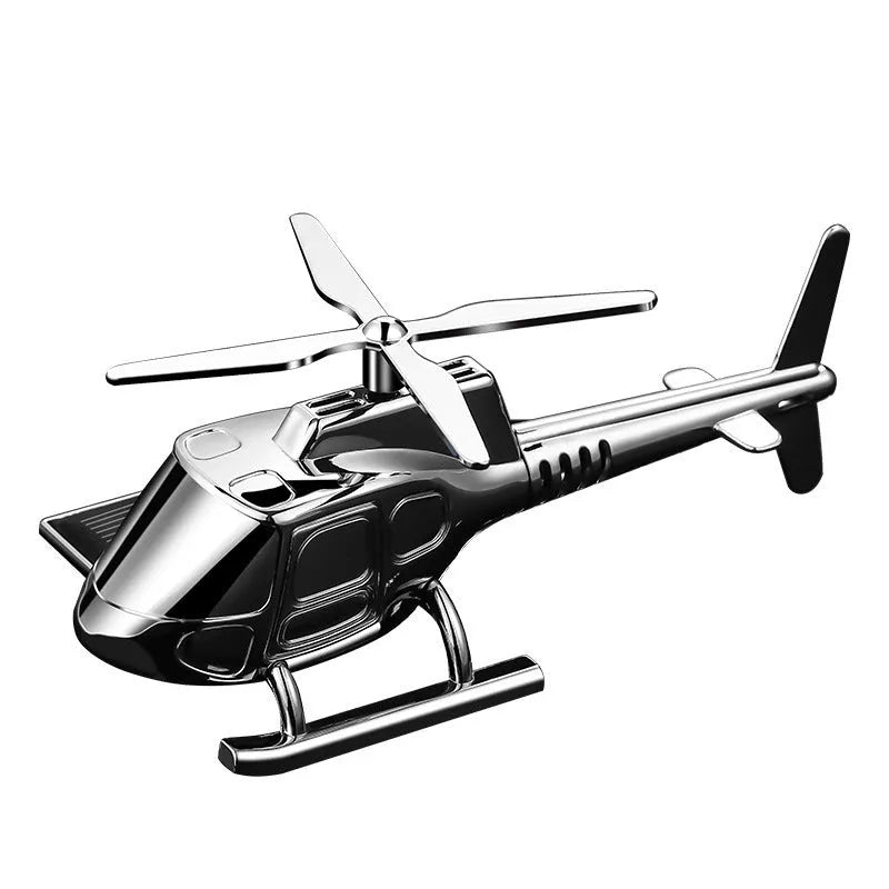 Helicopter car interior decoration model in silver colour on car dashboard