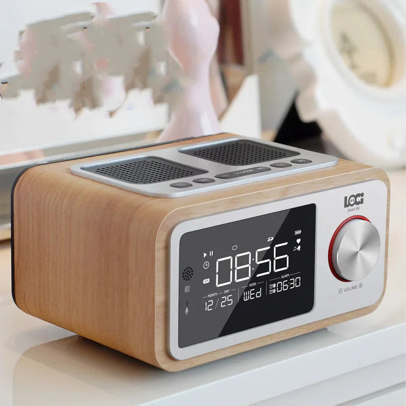 Wooden Bluetooth speaker alarm clock radio in golden oil colour on a bedside table.
