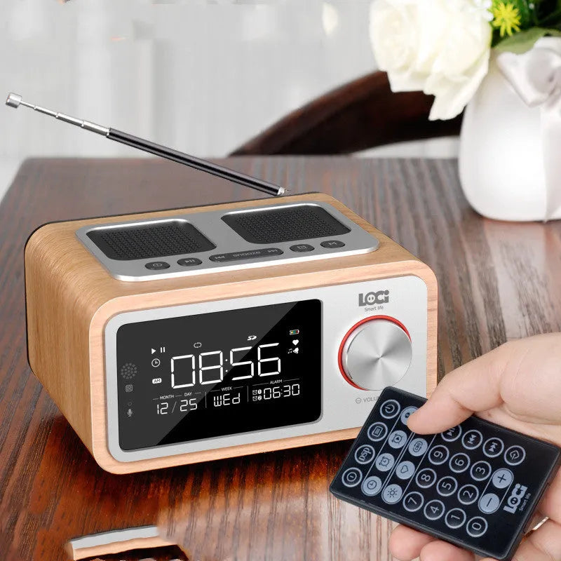 Wooden Bluetooth speaker alarm clock radio in golden oil colour on a bedside table.